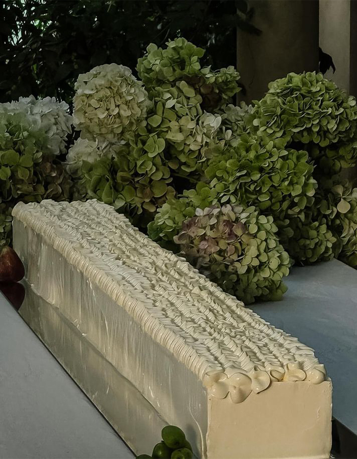 7 Wedding Cake Trends for 2025: Inspiring Designs for Modern Couples 8 Editorial-style photo of a green sheet cake surrounded by green hydrangea flowers.