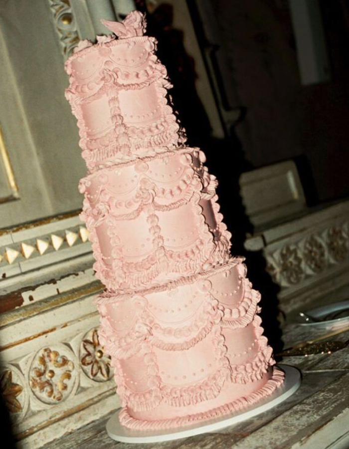 7 Wedding Cake Trends for 2025: Inspiring Designs for Modern Couples 2 maximalist pink 3-tier wedding cake photographed in editorial style - tilted and with flash