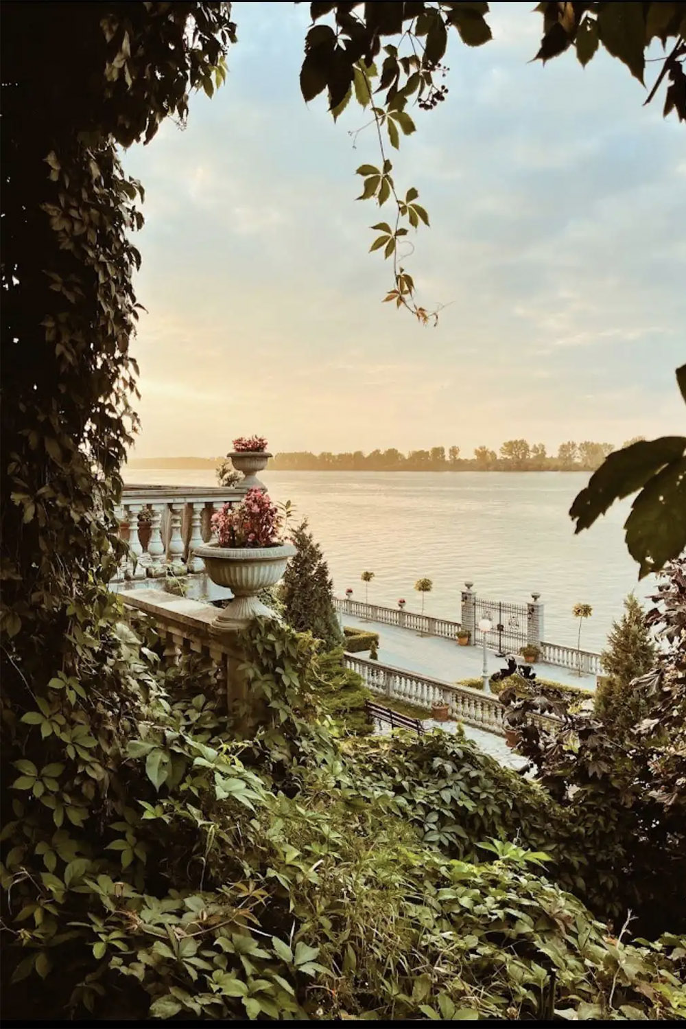 Overlooking the Danube River at Villa Jugovo, lush gardens and classical terraces frame the waterfront view, photographed in an editorial style that highlights the venue’s elegant, destination-wedding charm.