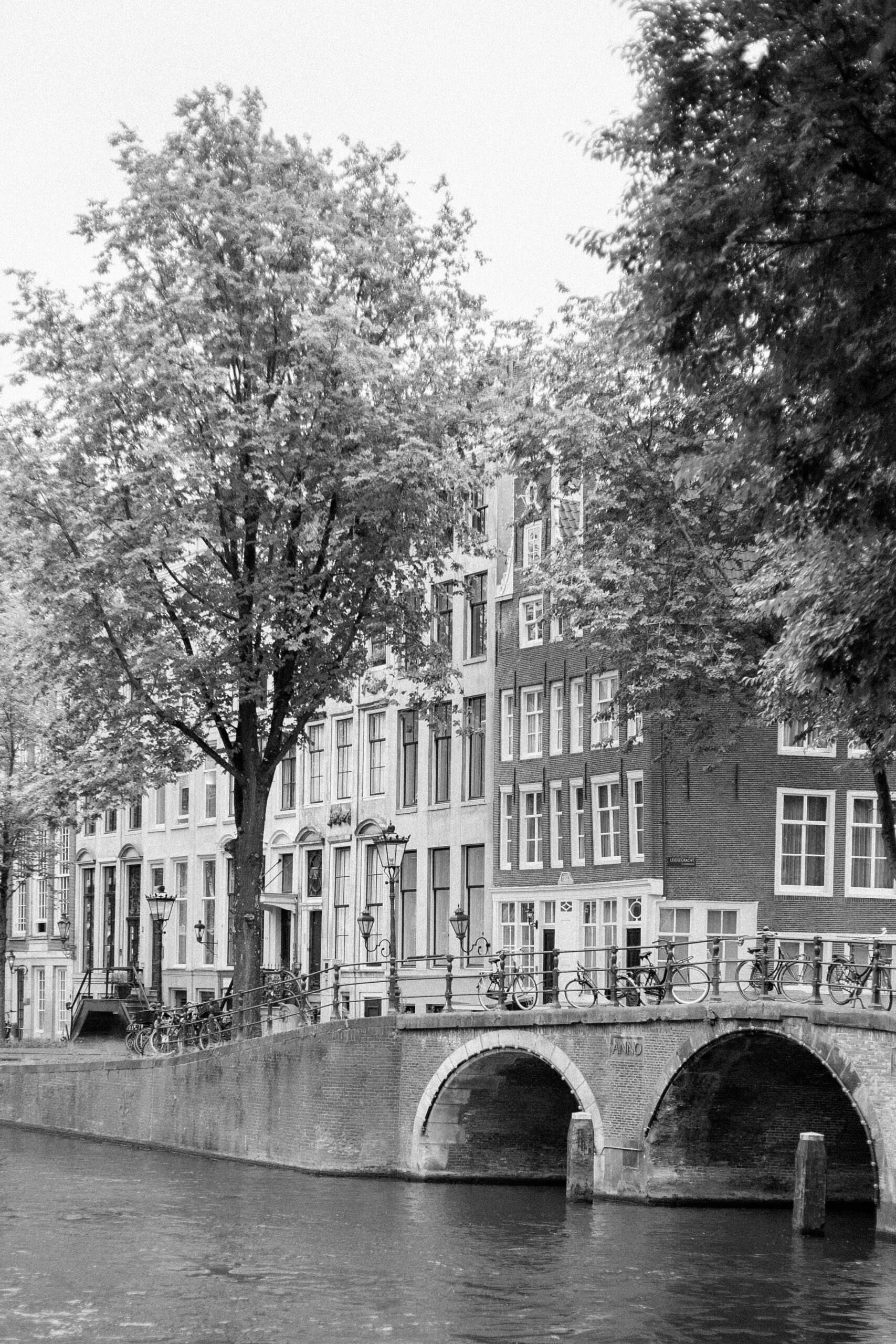 Planning a Surprise Proposal? Hire an Engagement Photographer in Amsterdam 3 Bridge over a canal in Amsterdam, with famous canal houses in the back