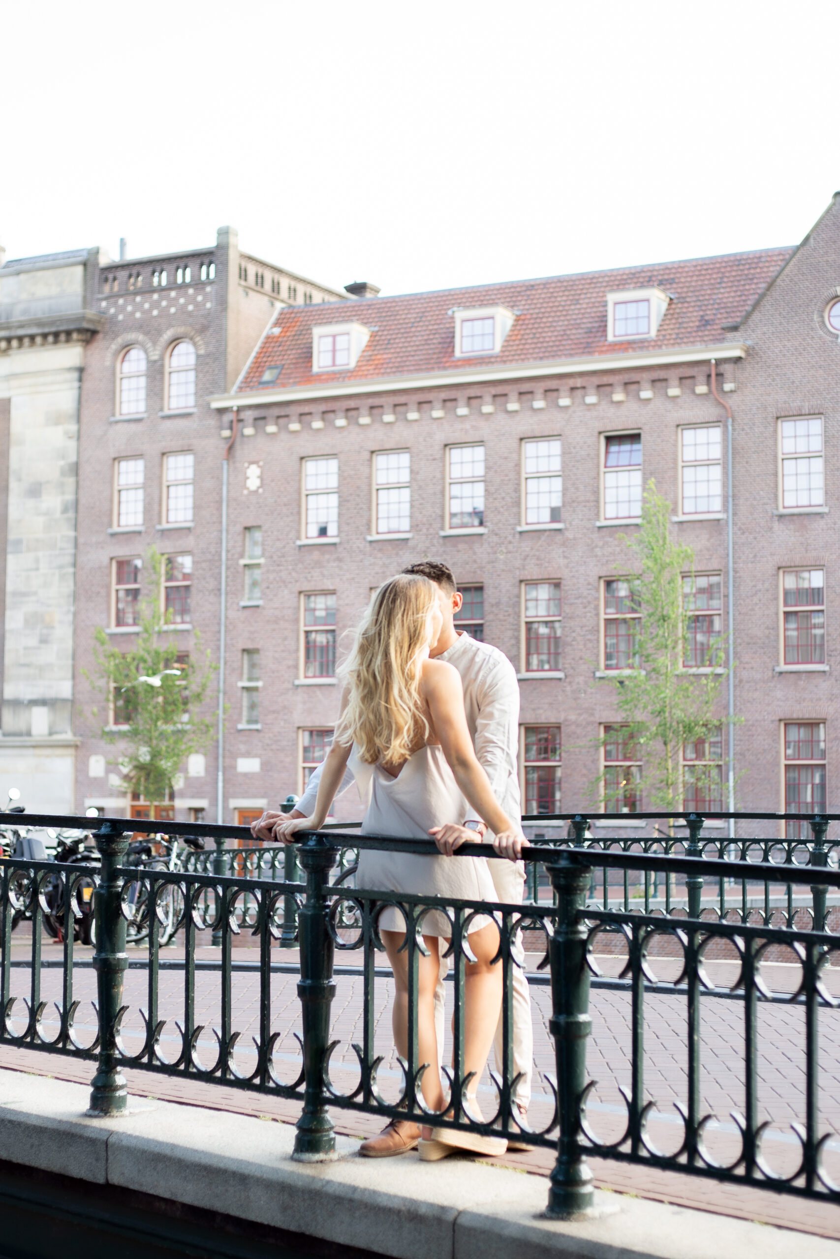 Planning a Surprise Proposal? Hire an Engagement Photographer in Amsterdam 10 Couple standing on a bridge in Amsterdam