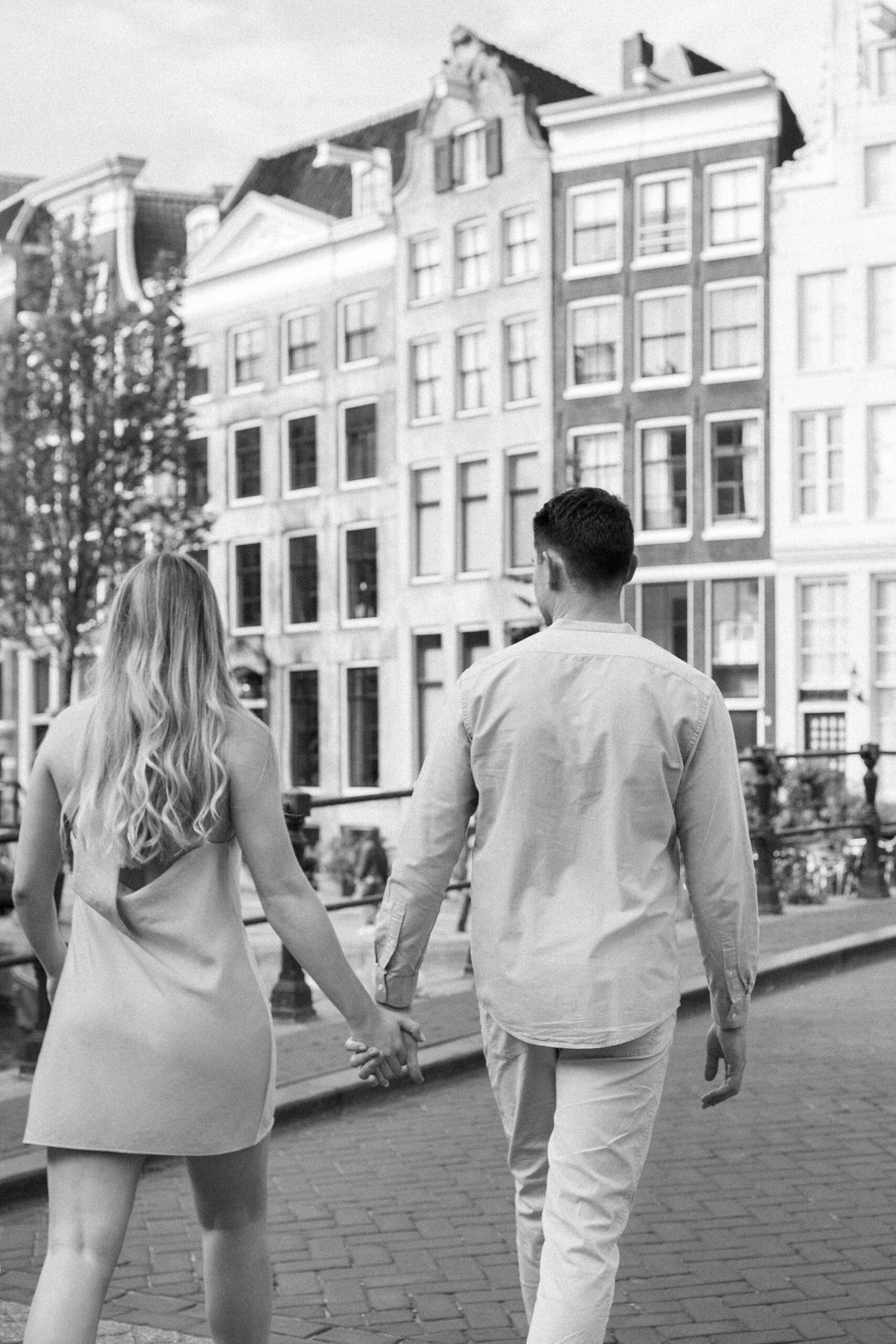 Couple Photoshoot in Amsterdam: A Romantic Escape Captured in Editorial Style 3 Couple walking in Amsterdam holding hands