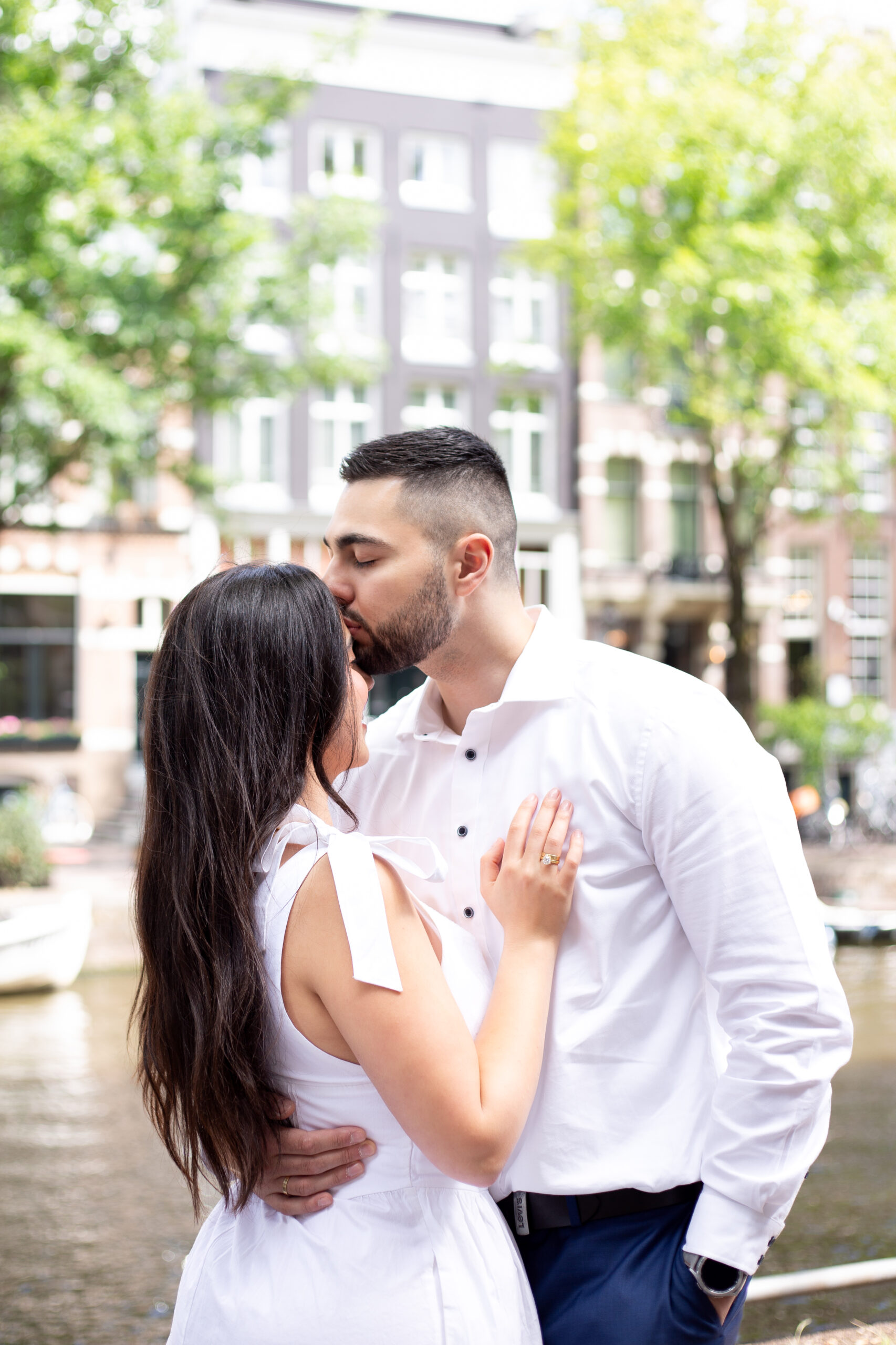 Photo of a groom kissing brides forehead - romantic elopement photography in Amsterdam