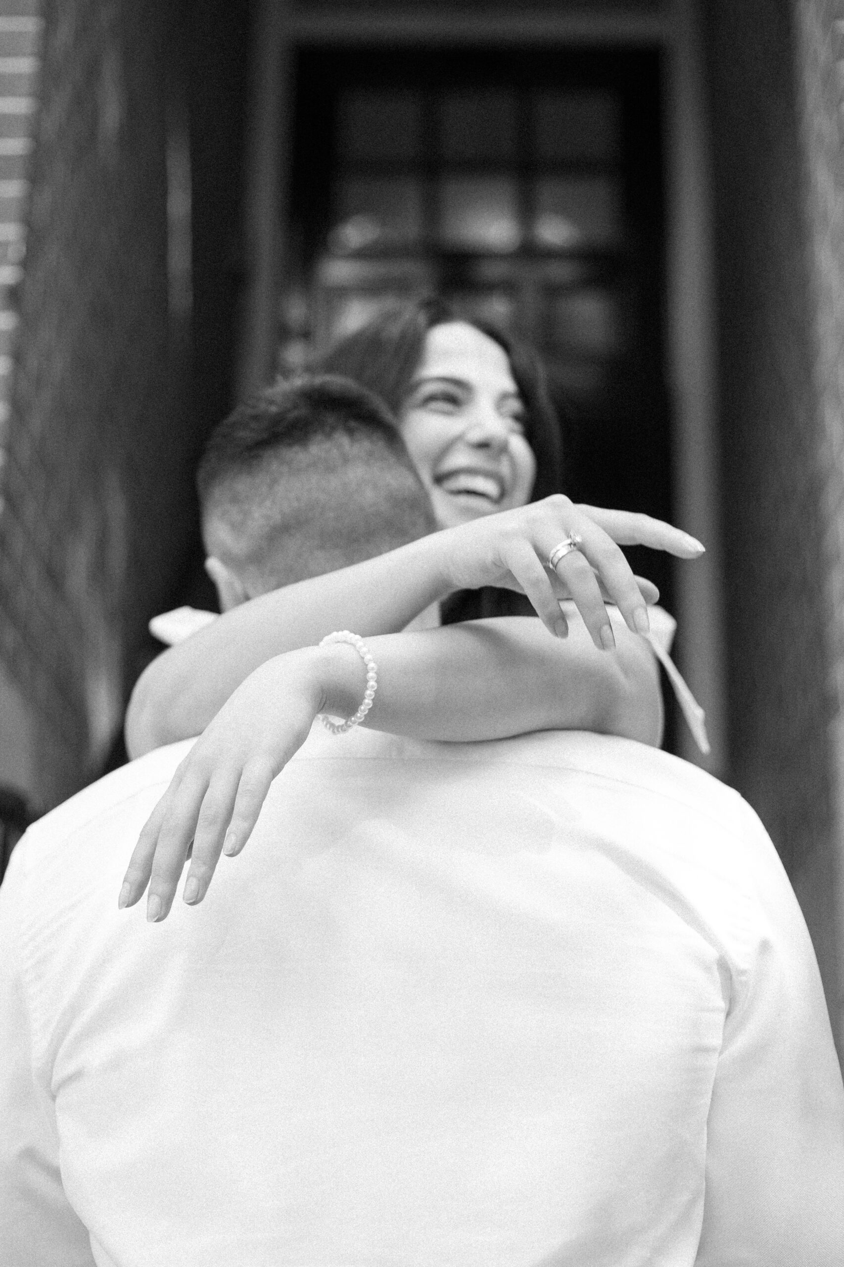 Black and white photo of a couple hugging and smiling after their Amsterdam elopement