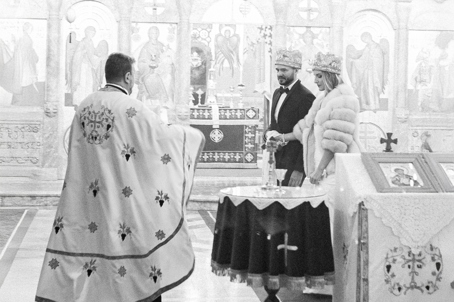 Church wedding in Belgrade, Serbia, captured in the style of analog black and white photography with an artistic touch.