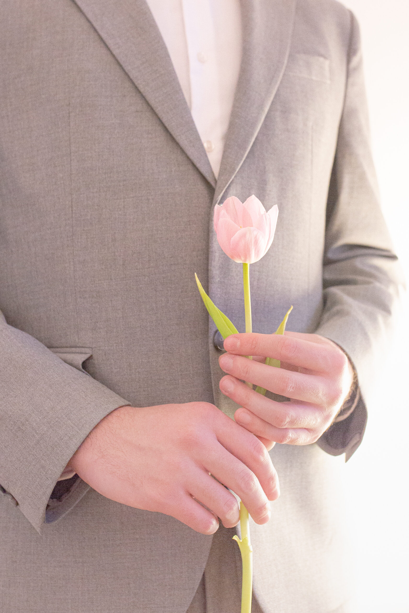 Planning a Surprise Proposal? Why You Need an Engagement Photographer in Belgrade 3 Close up photo of the man holding a flower, preparing to propose to his partner