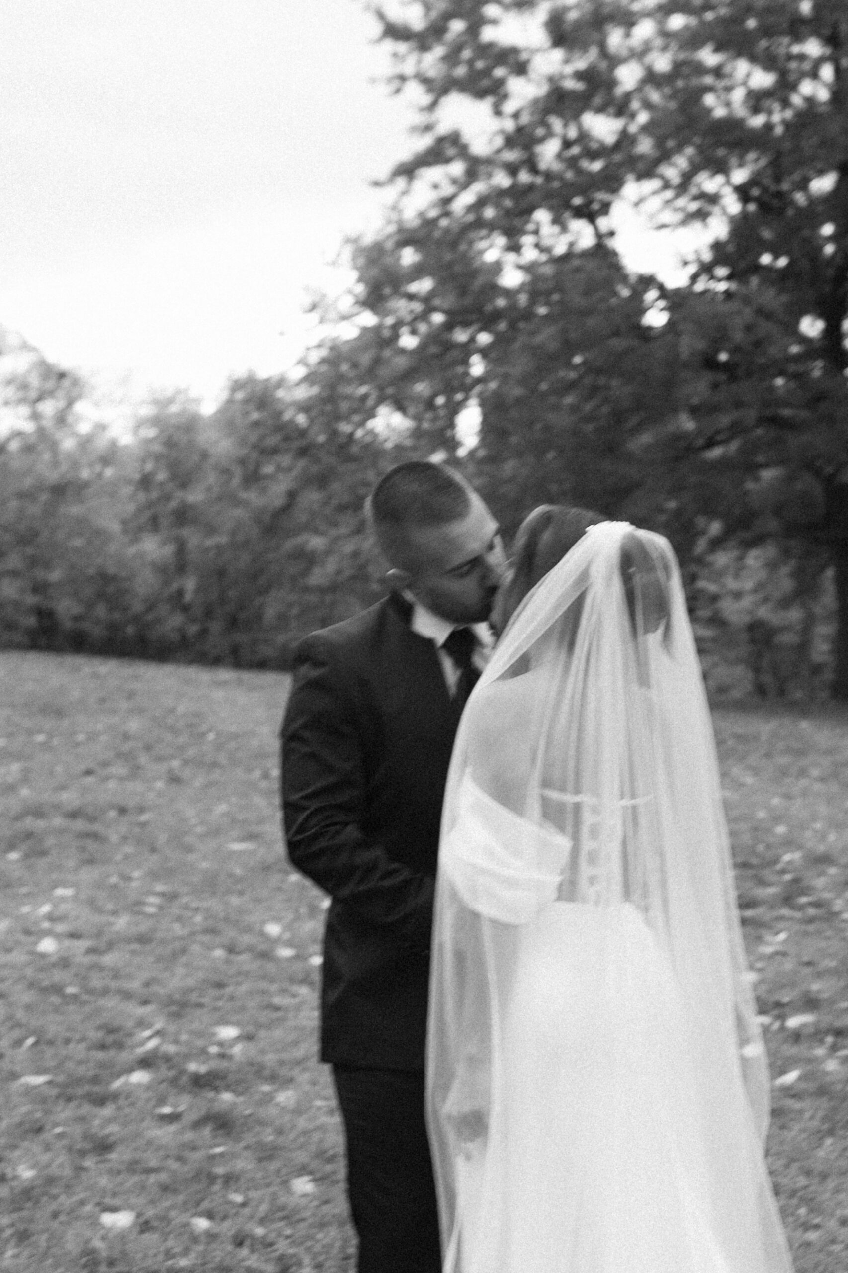Bride and groom kissing on their wedding day, photographed with motion blur