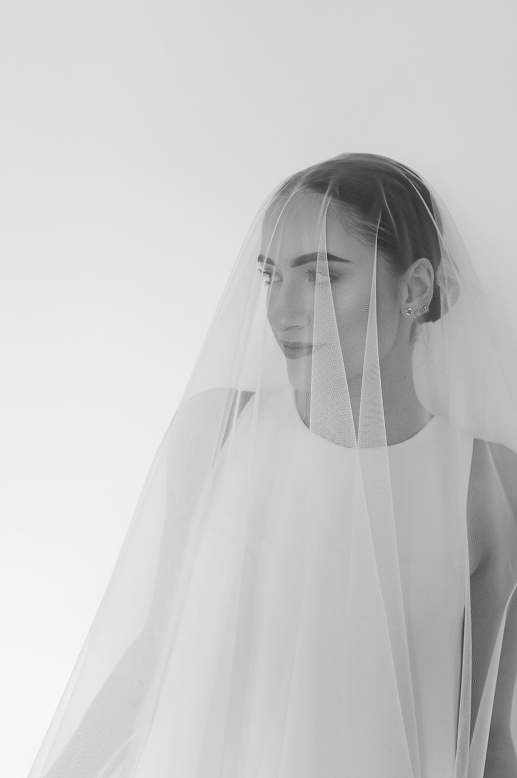 modern editorial style portrait of the bride with the wedding veil