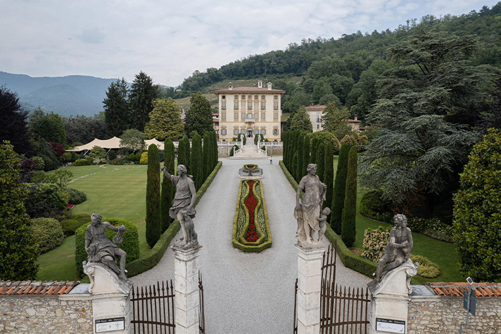 Bergamo, Italy grand villa and formal gardens with statues and symmetrical pathways, photographed in a refined editorial landscape style.